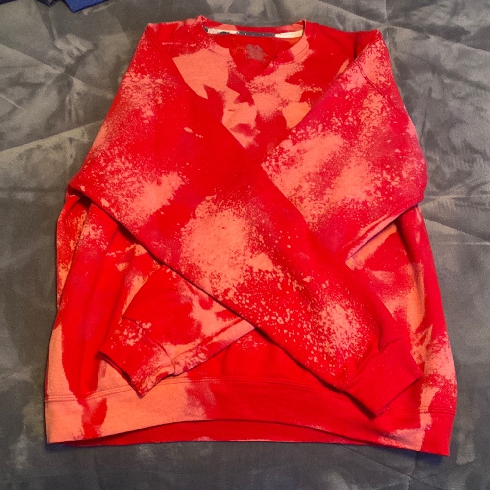 A bleach-dyed red crewneck